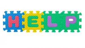 Piezas de un juego de letras que juntas forman la palabra "help"